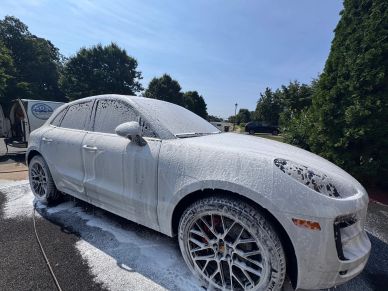 Car covered in foam during a wash.
