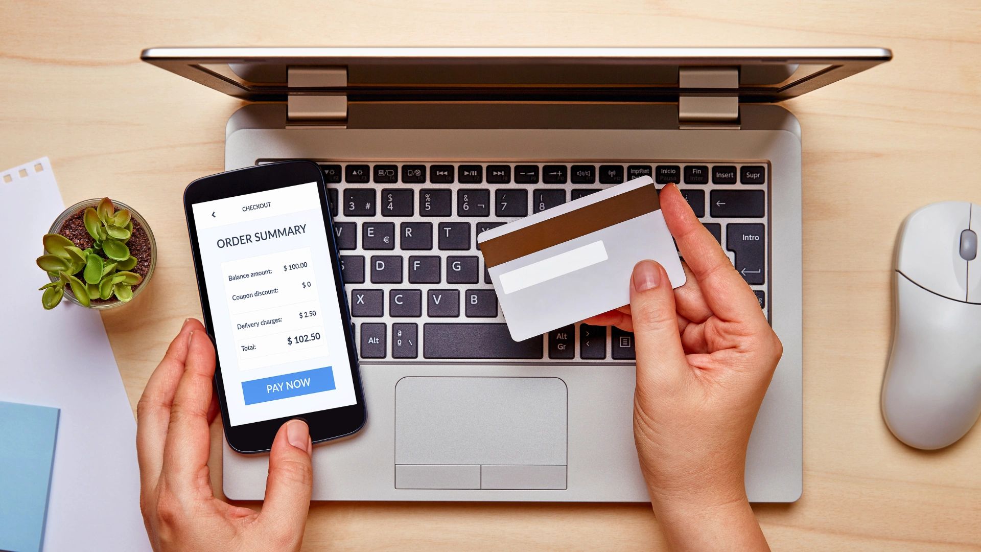 A person making an online purchase using a smartphone and credit card.