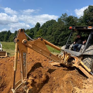 Excavator digging soil at construction site.