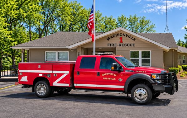 Madisonville Fire-Rescue truck parked in front of the station.