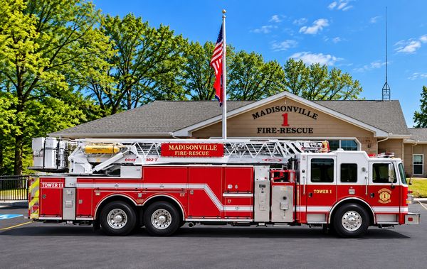 Madisonville Fire-Rescue truck parked outside fire station.