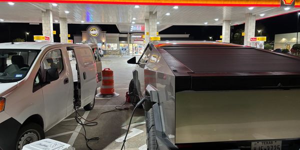 Mobile EV Fast Charge charging a Tesla Cybertruck at a gas station at night.