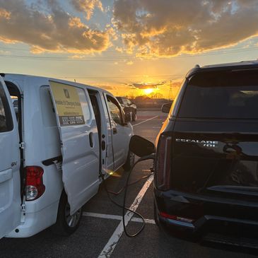 Mobile EV charger truck assisting Cadillac Escalade that did not have enough range miles to get to a