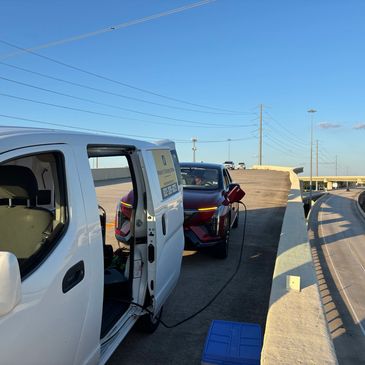 Mobile emergency roadside EV charge on the state highway overpass to airport