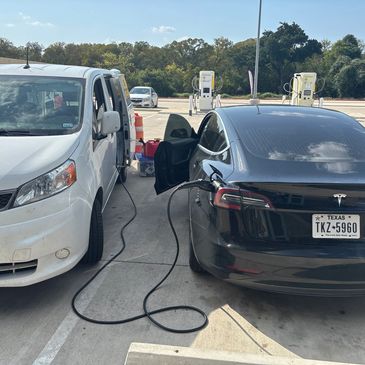 Mobile EV charger truck assisting Tesla that did not have enough range miles to get to airport parki