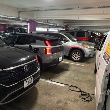 Mobile EV charging of Audi in IAH Houston Intercontinental Airport parking garage Terminal D.