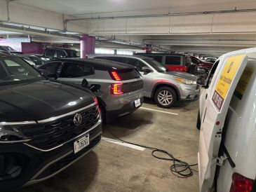 Mobile EV car charging service at the Houston Intercontinental Airport for a silver Volvo EV car