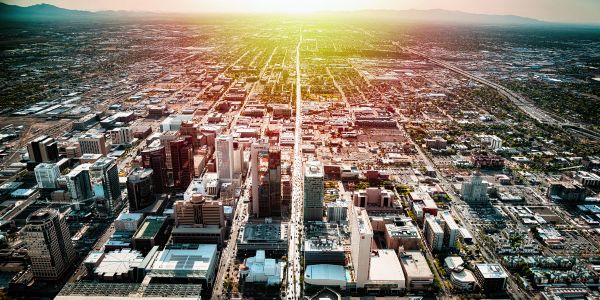 Aerial view of a city during sunset with sunlight.