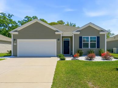 Single-story modern house with garage and garden.