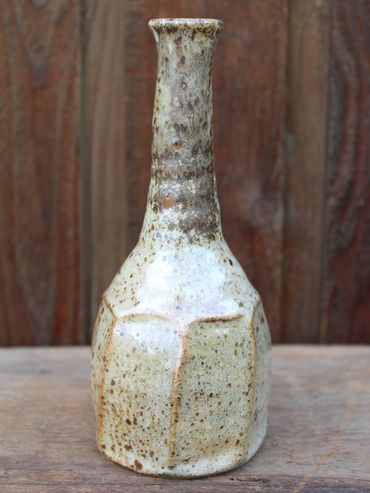 Gas fired shino bottle with wild sand wedged into the clay
