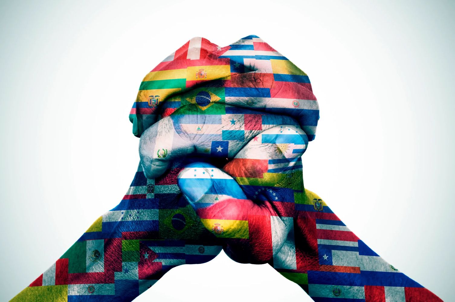 Two hands clasped together with Latin American flags overlay.
