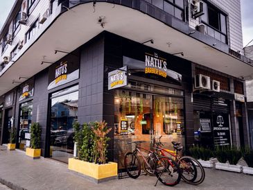 Corner view of Natú's Burger Shop with bicycles parked outside.