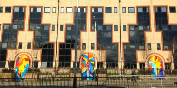 Colorful murals on building walls with geometric patterns.