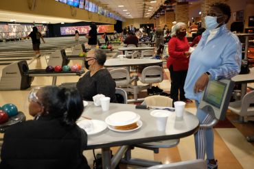 People socializing at a bowling alley.