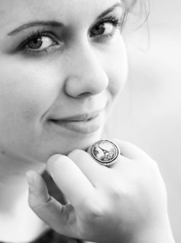 Close-up of a woman with a ring on her finger.