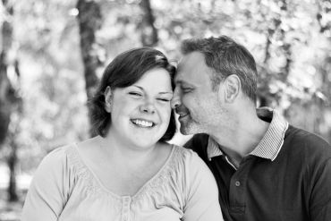 Couple sharing a joyful moment outdoors.