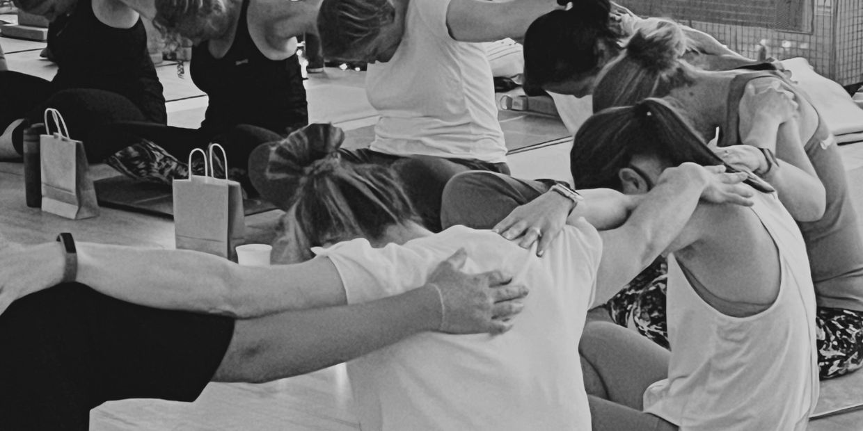 Women supporting and encouraging each other during a warm, welcoming yoga retreat in Peterborough, c