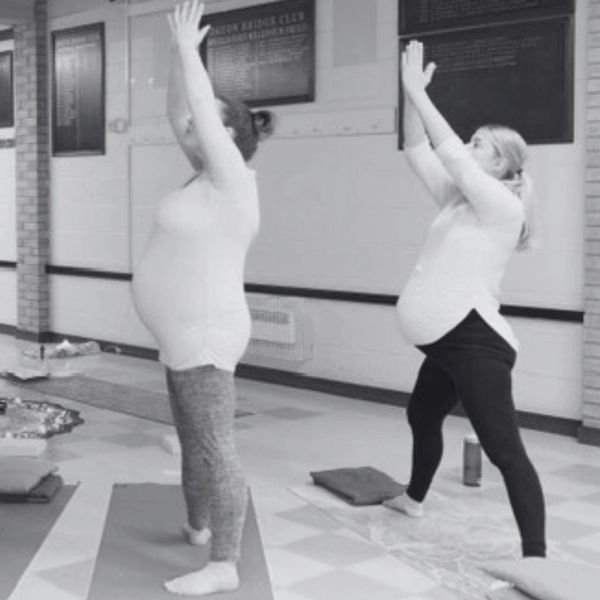 Two pregnant women practicing yoga moves during a Peterborough Pregnancy Yoga Class