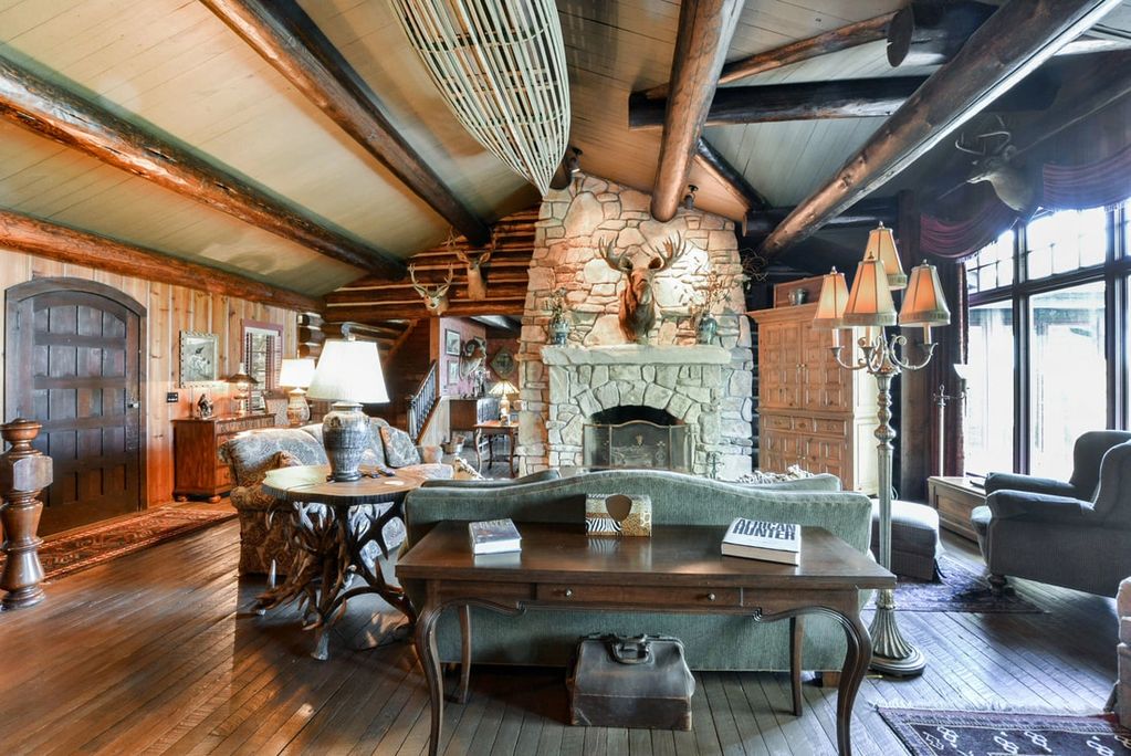 Grand living room with beaver creek limestone fireplace, moose head mount and amazing view overlooki