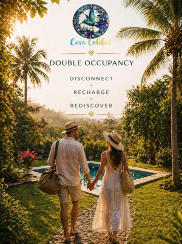 Couple walking hand in hand towards a pool at Casa Colibri, promoting double occupancy stay.