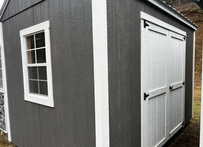 Grey shed with double doors and window