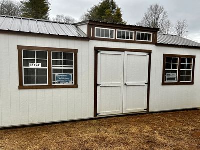 white dormer shed with double doors and four windows