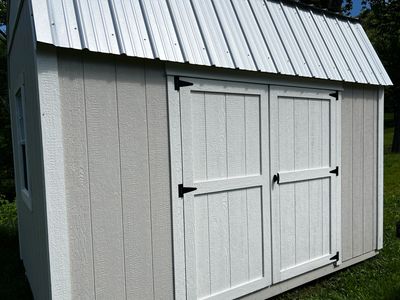 beige shed with white double doors
