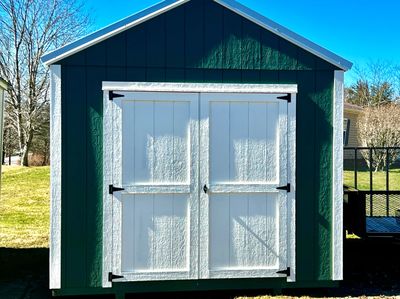 green shed with white double doors