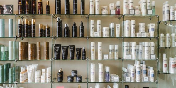 Shelves filled with various hair and skincare products in a beauty store.