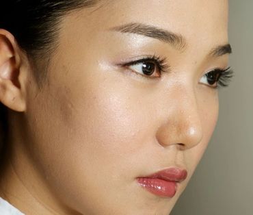 Beautiful woman apply makeup on face with livestock
