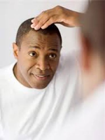 Man checking his hair in the mirror.