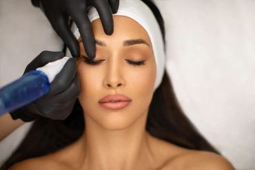 Woman trimming eyebrow