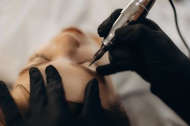 Woman trimming eyebrow