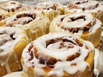 Freshly baked cinnamon rolls with icing.