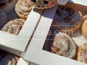 Boxes of cinnamon rolls with icing.
