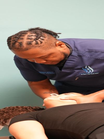 Chiropractor adjusting patient's neck.