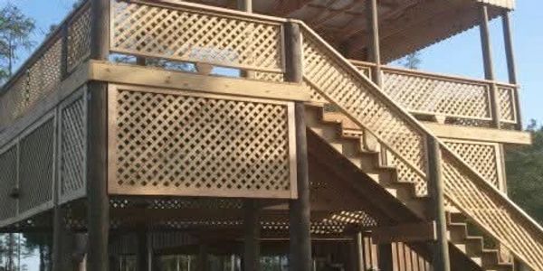 Wooden elevated structure with stairs and lattice panels.