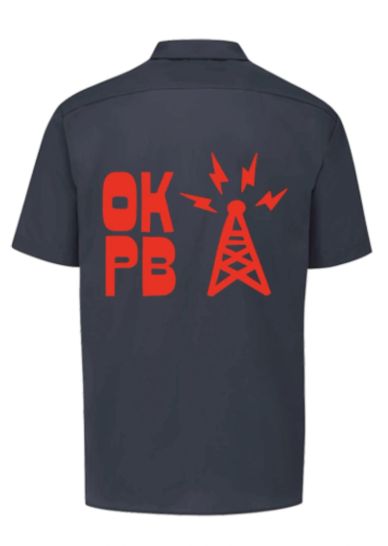 Dark shirt with red OKPB and radio tower design on back.
