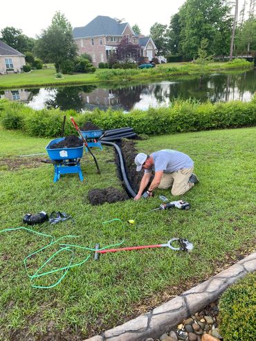 Residential French drain installation to fix standing water in Leland NC