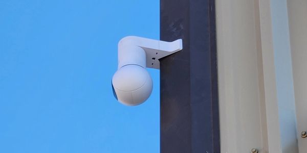 PTZ network Camera mounted on the corner of a building.