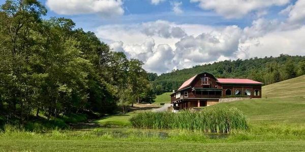 The wedding and event venue - the Chalet - at Robbins Paradise Ranch taken from dock on the pond.