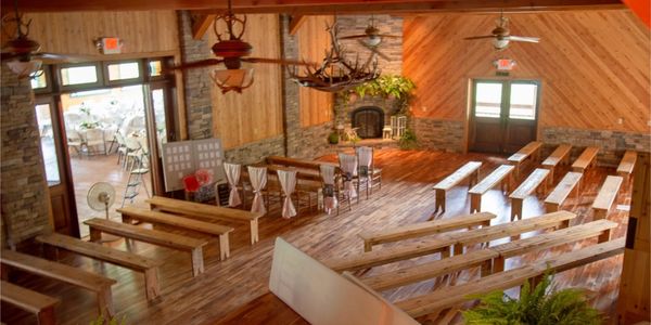 Wooden benches set up in elegant and rustic venue ready for a wedding ceremony