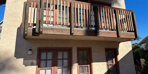 Wood balcony and exterior stucco detail from the AWC project gallery.