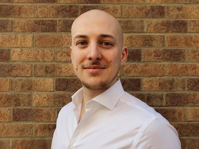 Ryan Gorman Founder of Lofthouse Group standing in front of a brick wall