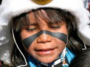 Child with face paint, looking up