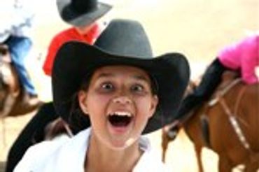 Cowgirl in a hat, mouth open in surprise
