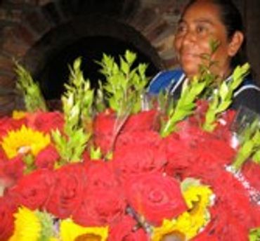 Arrangement of bright red flowers with green foliage