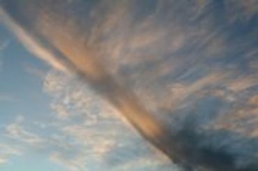 Swirling cloud formation in a blue and orange sky