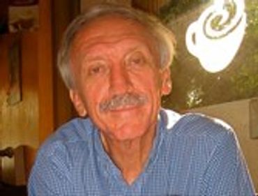 Older man with a mustache, looking at the camera