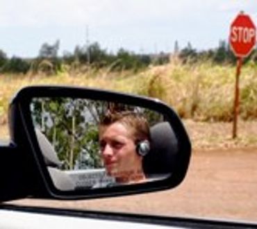 Man reflected in a car's side mirror